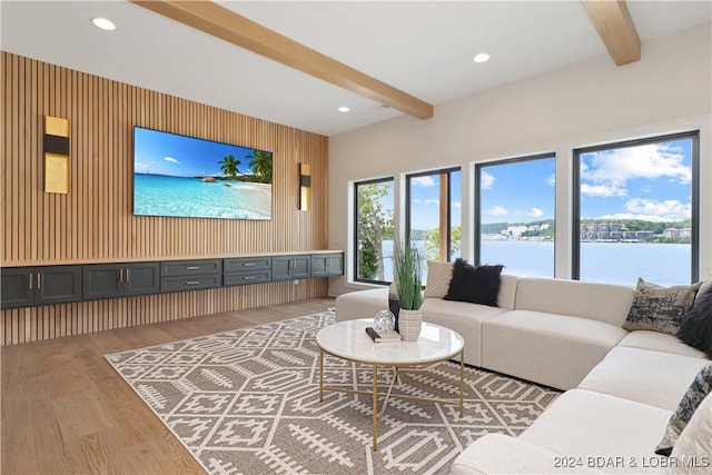 living room featuring wood walls, beamed ceiling, and wood-type flooring