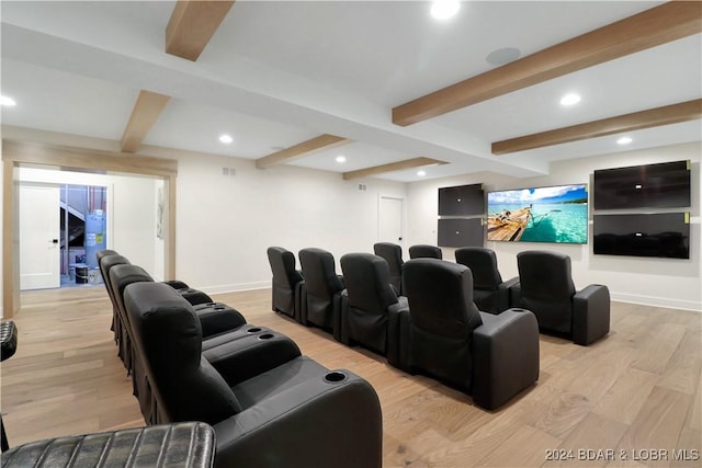 cinema room featuring beamed ceiling and light hardwood / wood-style flooring