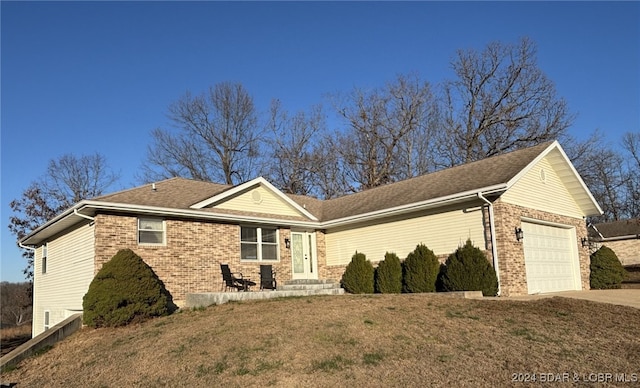 view of front of house with a garage and a front lawn