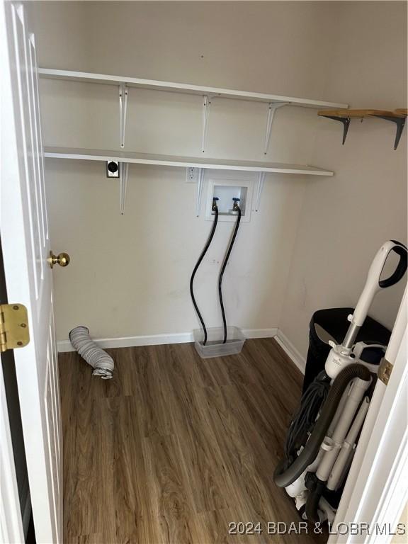 laundry room featuring dark hardwood / wood-style floors and hookup for a washing machine