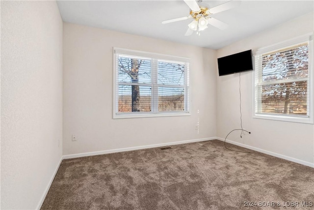 carpeted empty room featuring ceiling fan