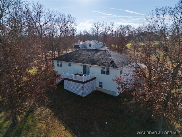 back of house with a deck