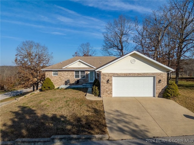 ranch-style home with a garage and a front yard