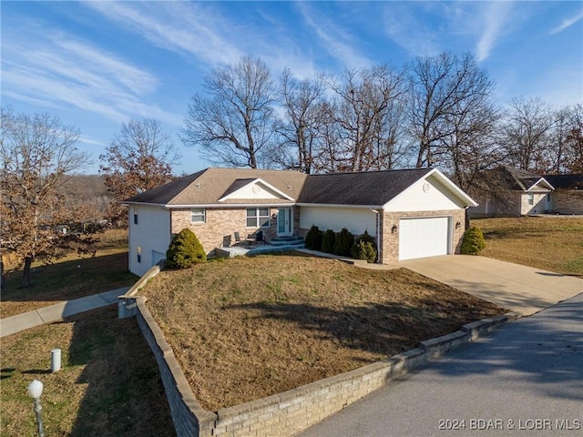 ranch-style home with a garage and a front yard