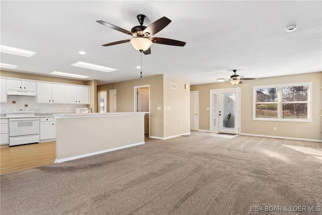 unfurnished living room with light carpet and ceiling fan