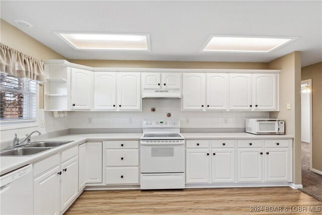 kitchen featuring white appliances, light hardwood / wood-style floors, sink, and white cabinets