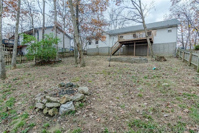 view of yard with a fire pit and a wooden deck