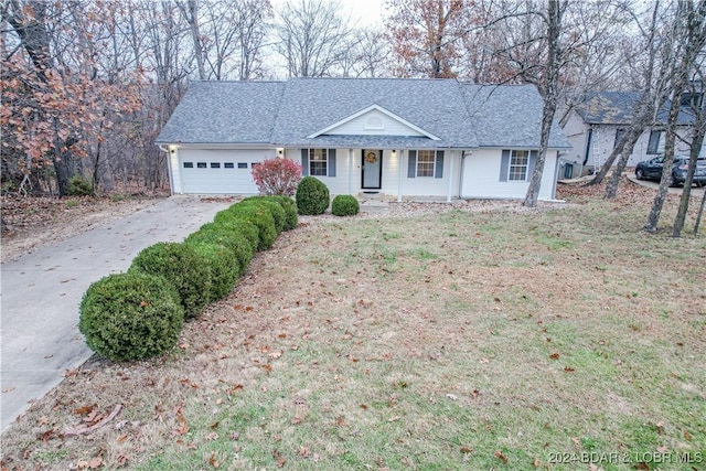 ranch-style home featuring covered porch and a garage