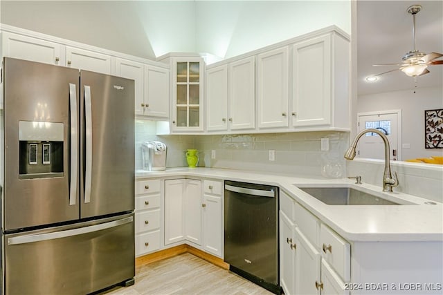 kitchen with a sink, ceiling fan, appliances with stainless steel finishes, and decorative backsplash