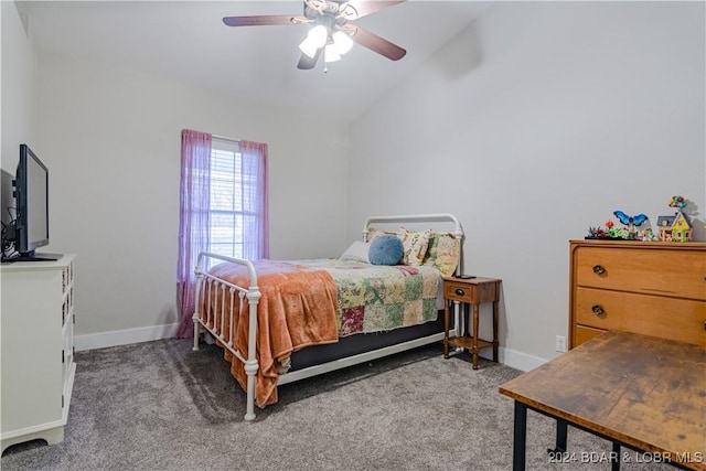 carpeted bedroom with ceiling fan, vaulted ceiling, and baseboards