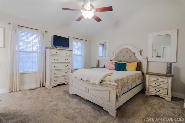 bedroom with visible vents, carpet flooring, vaulted ceiling, and baseboards