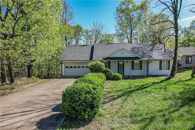 single story home with concrete driveway, a front lawn, an attached garage, and roof with shingles