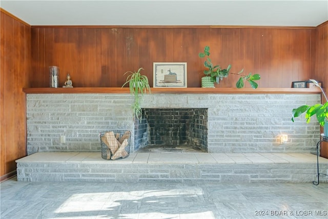 details featuring a brick fireplace and wood walls