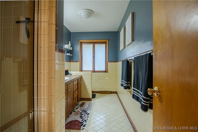 bathroom with vanity, tile walls, and tile patterned floors