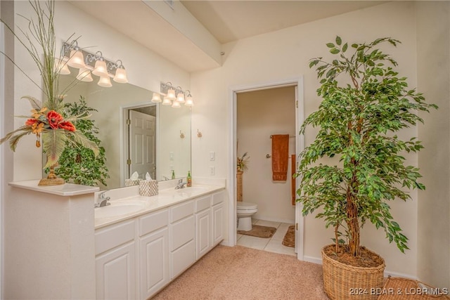 bathroom featuring tile patterned floors, vanity, toilet, and an inviting chandelier