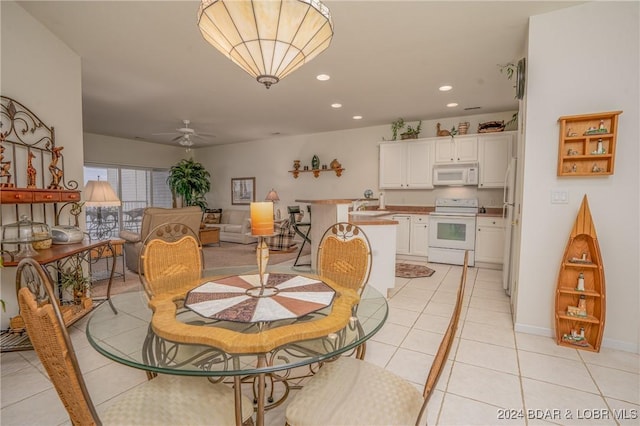 dining space featuring ceiling fan and light tile patterned flooring