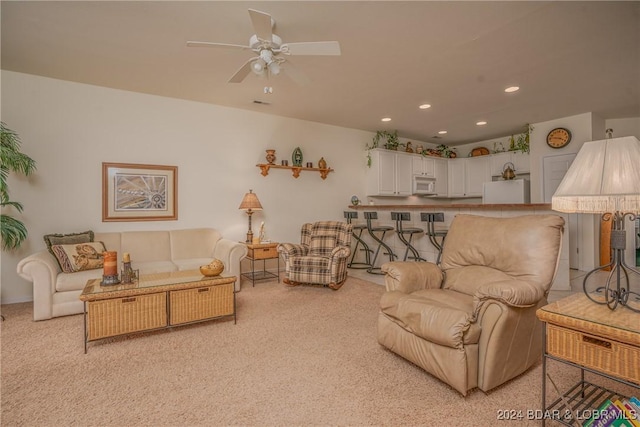 carpeted living room featuring ceiling fan