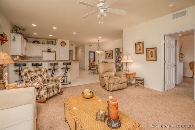 carpeted living room with ceiling fan