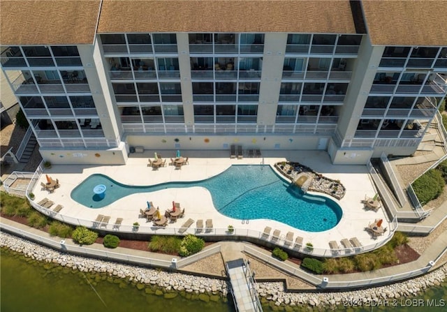 view of swimming pool featuring a water view