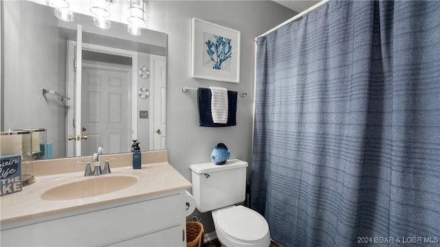 bathroom featuring vanity and toilet