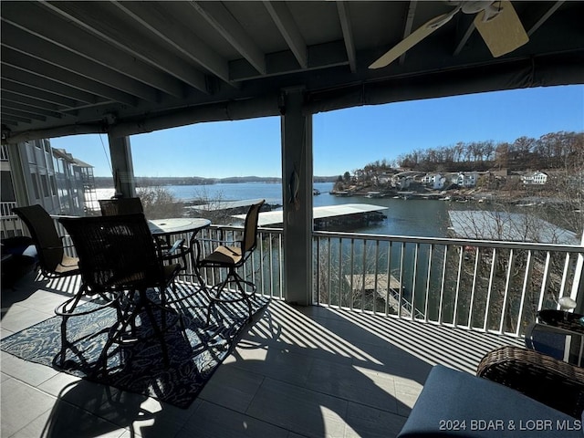 wooden deck featuring ceiling fan and a water view