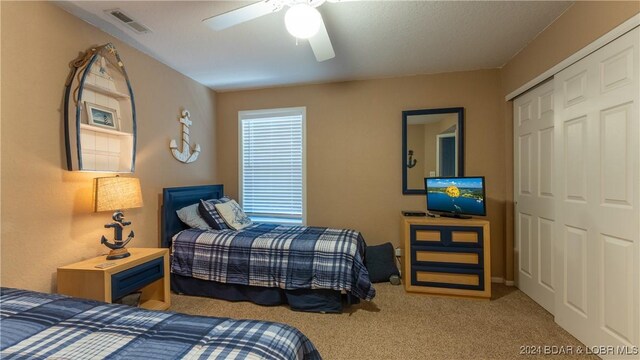 bedroom featuring carpet flooring, a closet, and ceiling fan