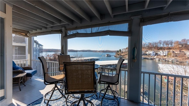 wooden terrace featuring a water view