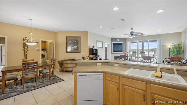 kitchen with white dishwasher, sink, ceiling fan, light tile patterned floors, and washer / clothes dryer