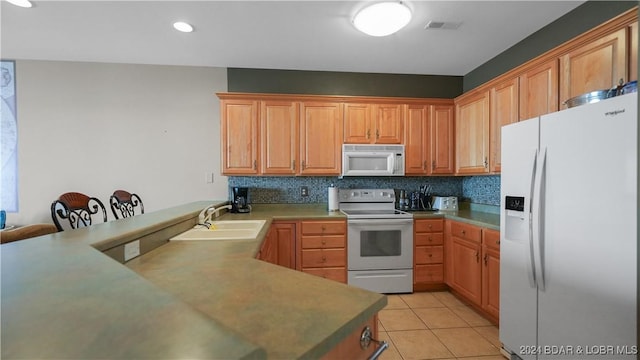 kitchen with kitchen peninsula, backsplash, white appliances, sink, and light tile patterned floors
