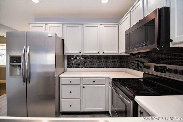 kitchen featuring stainless steel appliances, white cabinets, and decorative backsplash