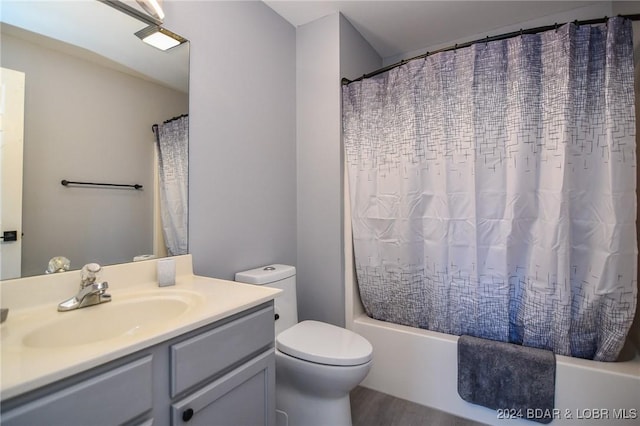 full bathroom featuring hardwood / wood-style floors, vanity, toilet, and shower / bath combo with shower curtain