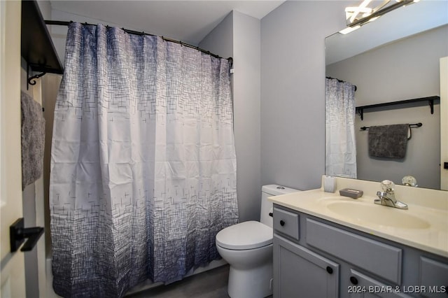 bathroom featuring vanity, curtained shower, and toilet