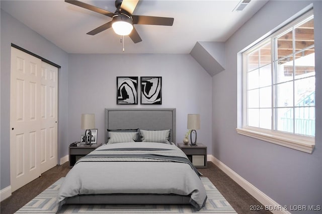 carpeted bedroom featuring ceiling fan and a closet