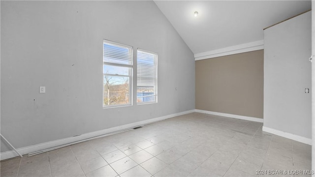 empty room featuring high vaulted ceiling