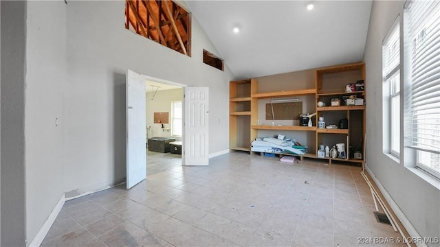 unfurnished office featuring high vaulted ceiling