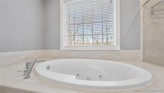 bathroom featuring a relaxing tiled tub