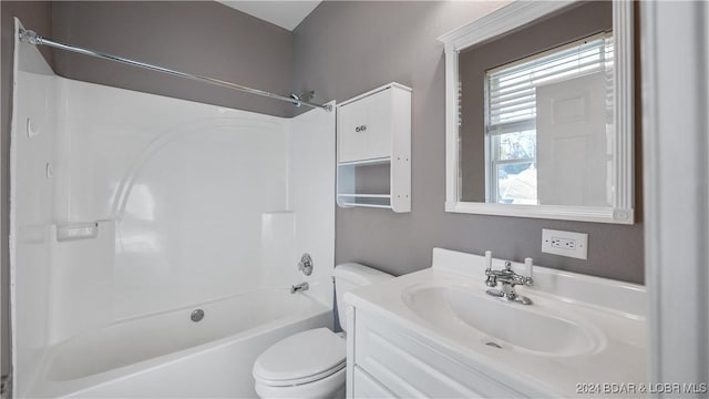 full bathroom with vanity, tub / shower combination, and toilet