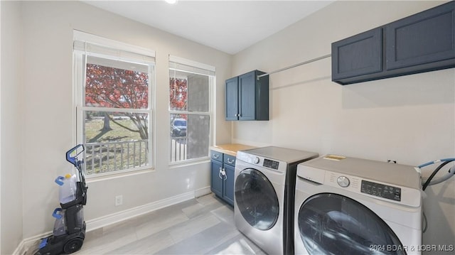 laundry area featuring cabinets and separate washer and dryer