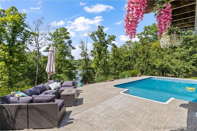 view of swimming pool featuring an outdoor living space and a patio