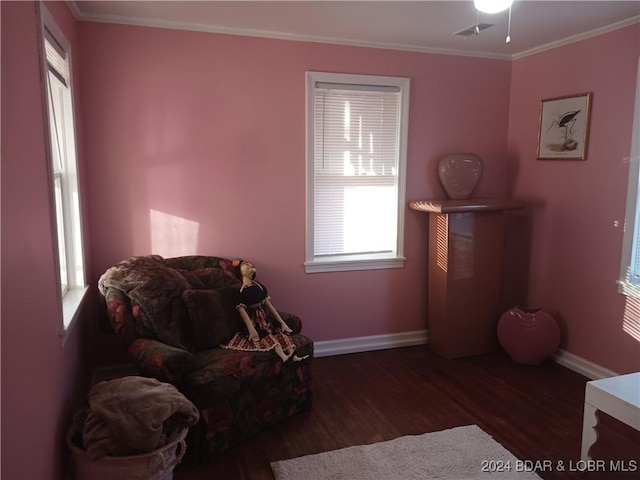 living area with dark hardwood / wood-style floors and ornamental molding