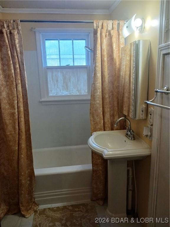 bathroom with shower / bath combo and crown molding