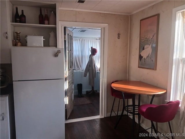 kitchen with white refrigerator, dark hardwood / wood-style floors, and crown molding