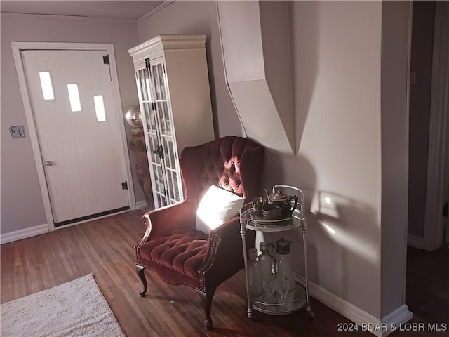 sitting room featuring hardwood / wood-style flooring and ornamental molding