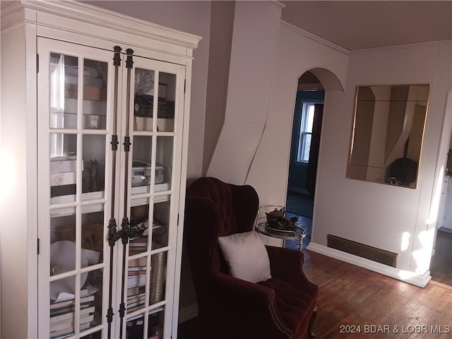 entryway featuring wood-type flooring and ornamental molding