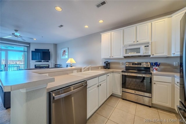 kitchen with white cabinetry, appliances with stainless steel finishes, sink, and kitchen peninsula