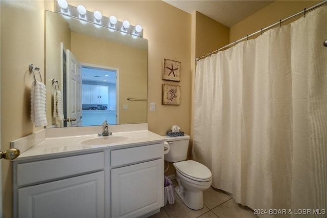 bathroom featuring vanity, tile patterned floors, and toilet