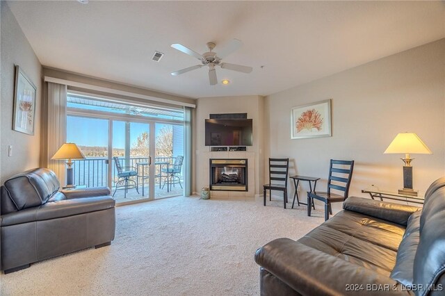 5450 Christopher Ln Unit 415, Osage Beach, MO 65065 - carpeted living room with ceiling fan and a tile fireplace