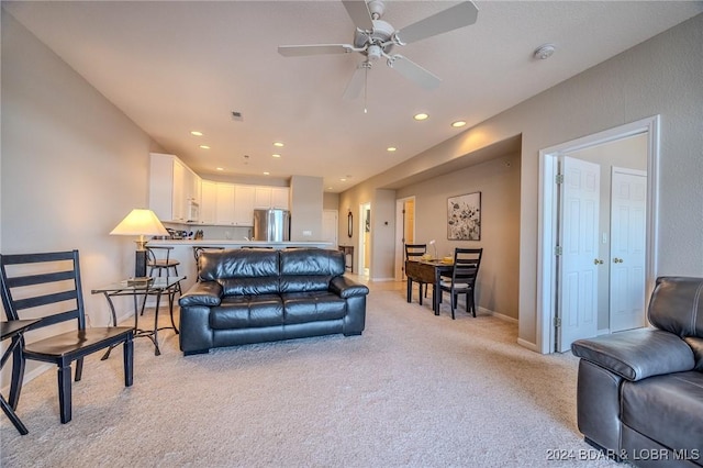 living room featuring ceiling fan and light carpet