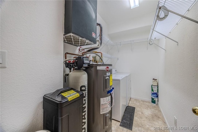 utility room with separate washer and dryer and water heater