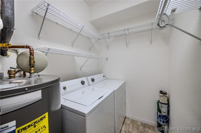 washroom with washer and clothes dryer and water heater